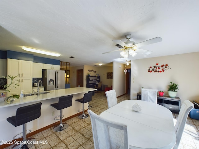 dining area with sink and ceiling fan