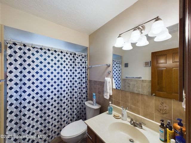 bathroom featuring vanity, tile walls, a shower with shower curtain, and toilet