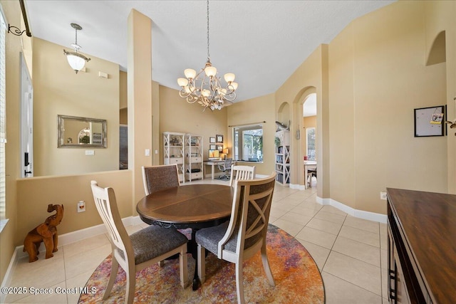 dining area featuring light tile patterned flooring and a notable chandelier