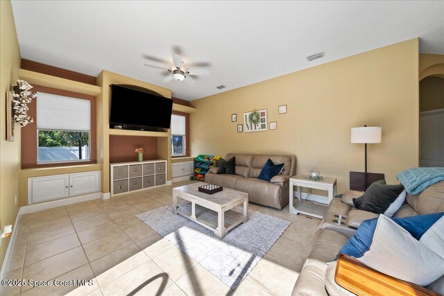 living room featuring light tile patterned floors and ceiling fan