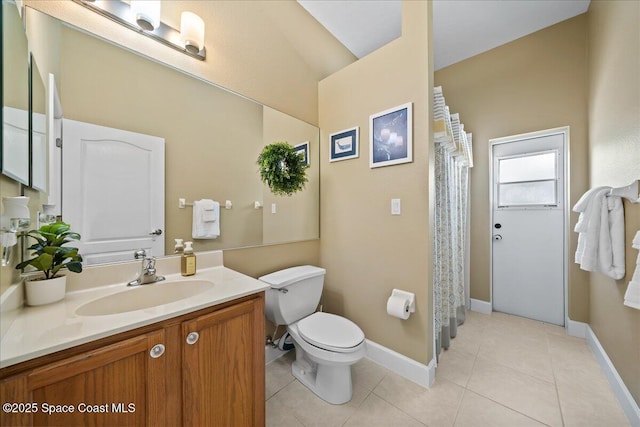 bathroom featuring vanity, tile patterned floors, and toilet