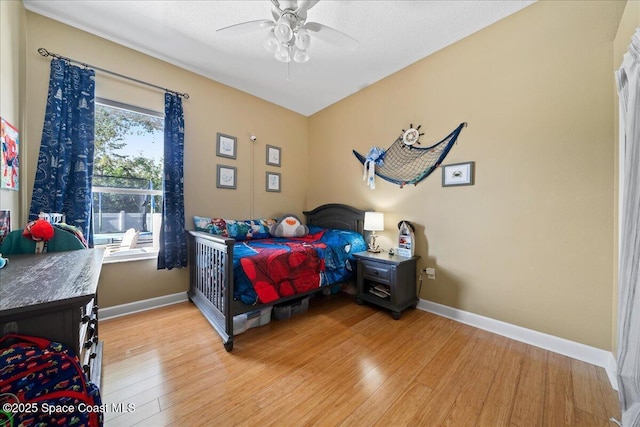 bedroom featuring ceiling fan and light hardwood / wood-style floors