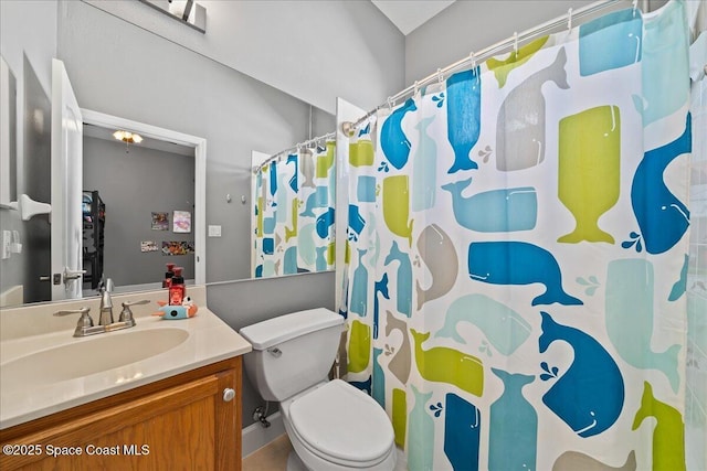 bathroom featuring walk in shower, vanity, and toilet