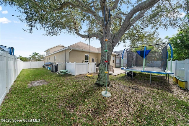 view of yard featuring a trampoline and a patio area