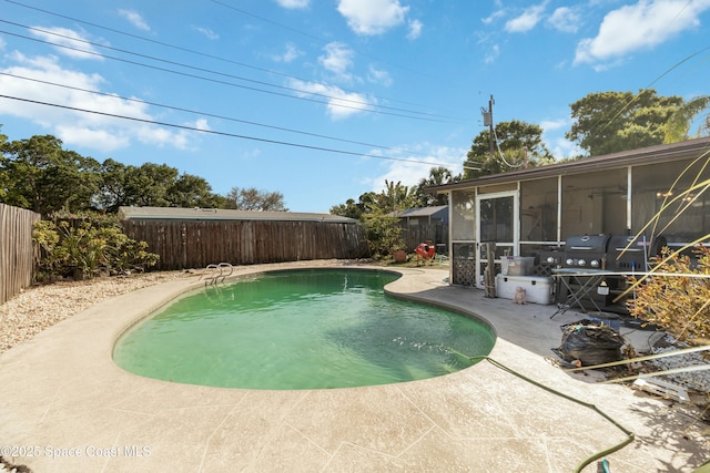 115 Carib Dr, Merritt Island, FL 32952 - view of swimming pool with a sunroom, a fenced backyard, and a patio area