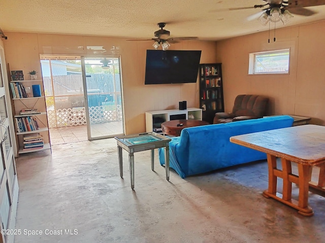 115 Carib Dr, Merritt Island, FL 32952 - living room with a ceiling fan, unfinished concrete flooring, and a textured ceiling