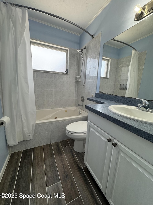 115 Carib Dr, Merritt Island, FL 32952 - full bathroom featuring ornamental molding, tiled shower / bath combo, wood finished floors, toilet, and vanity