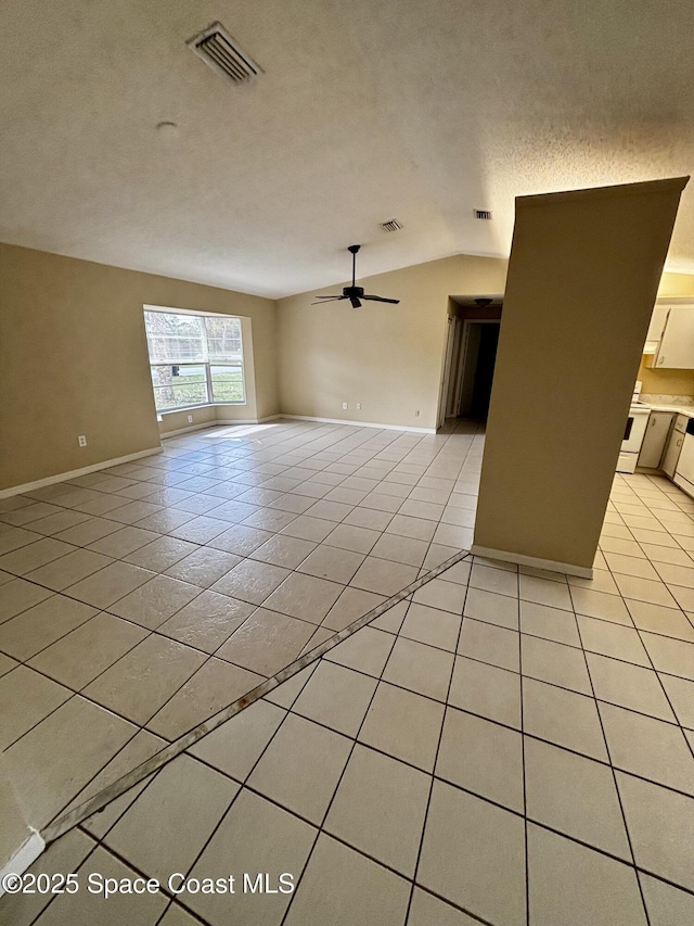 unfurnished living room with ceiling fan, lofted ceiling, a textured ceiling, and light tile patterned floors