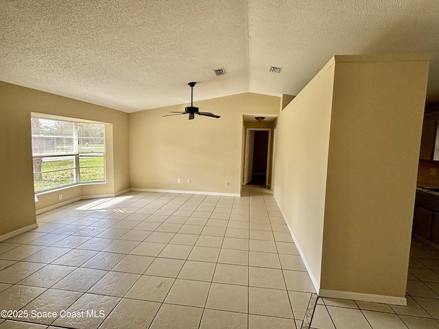 unfurnished room featuring lofted ceiling, light tile patterned floors, a textured ceiling, and ceiling fan