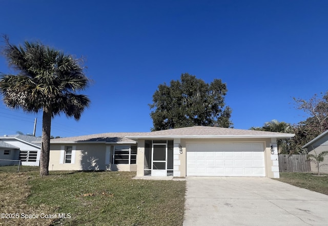 single story home featuring a garage and a front lawn