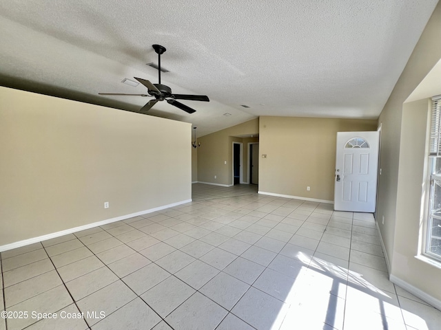 unfurnished living room featuring lofted ceiling, light tile patterned floors, a textured ceiling, and ceiling fan