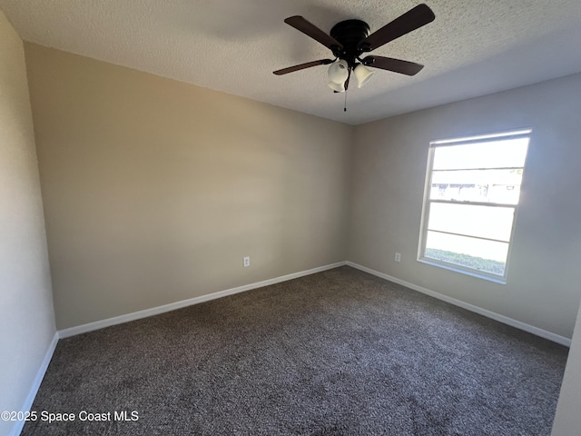 carpeted empty room with ceiling fan and a textured ceiling