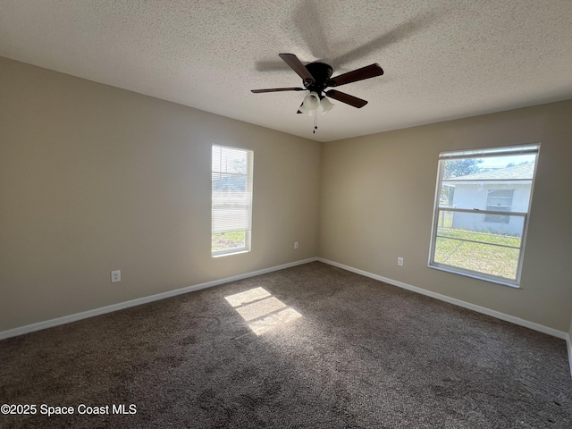 carpeted spare room featuring ceiling fan and a textured ceiling