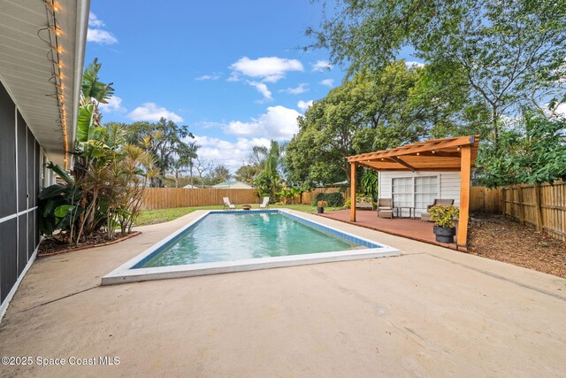 view of swimming pool featuring a patio area and a deck