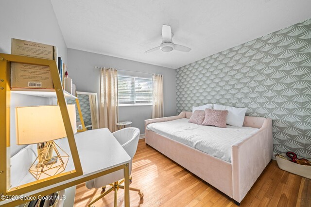 bedroom with wood-type flooring and ceiling fan