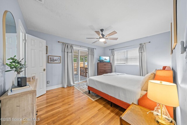 bedroom featuring hardwood / wood-style floors, access to exterior, and ceiling fan