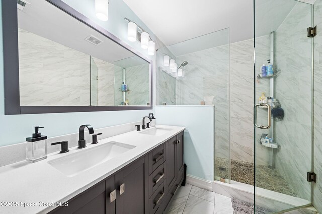 bathroom featuring vanity and a shower with door