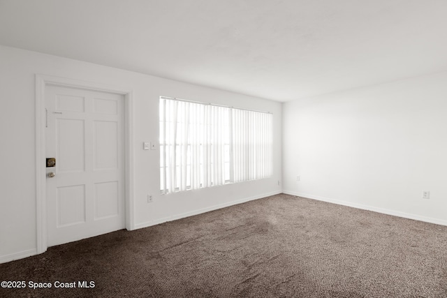 3765 S Hopkins Ave Unit 4A, Titusville, FL 32780 - unfurnished room featuring dark carpet and baseboards