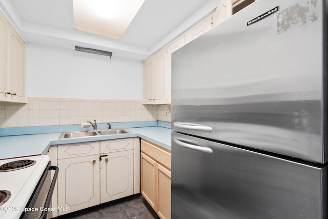 3765 S Hopkins Ave Unit 4A, Titusville, FL 32780 - kitchen with light countertops, a sink, freestanding refrigerator, and decorative backsplash