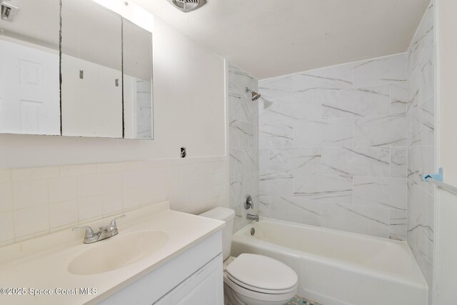 3765 S Hopkins Ave Unit 4A, Titusville, FL 32780 - bathroom featuring visible vents, toilet, tub / shower combination, vanity, and tile walls