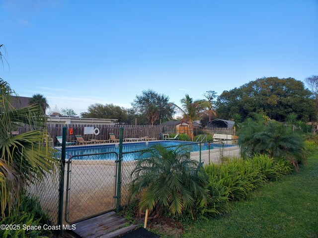 3765 S Hopkins Ave Unit 4A, Titusville, FL 32780 - pool featuring a gate and fence