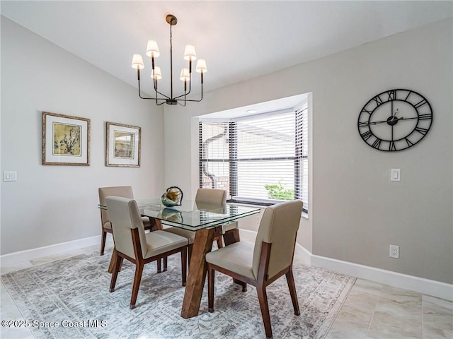 dining space with an inviting chandelier and vaulted ceiling