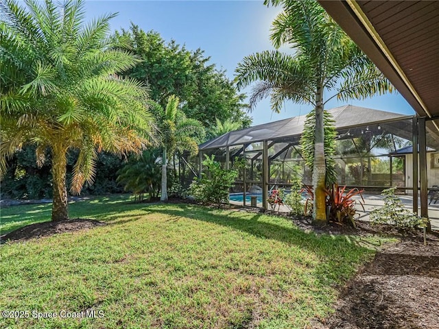 view of yard with a lanai and a patio