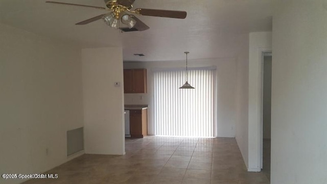 spare room with tile patterned floors and ceiling fan