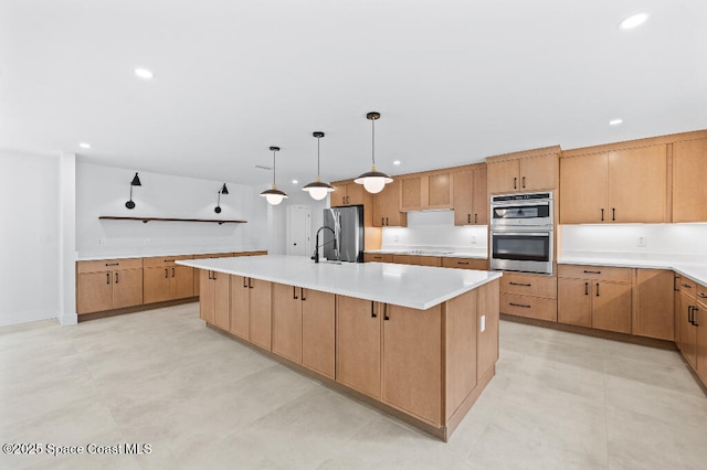 kitchen featuring stainless steel appliances, a kitchen island with sink, pendant lighting, and light brown cabinets