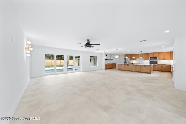 unfurnished living room featuring ceiling fan