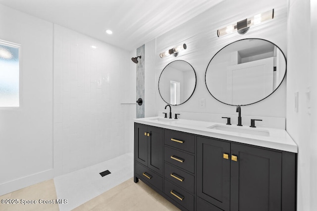 bathroom featuring vanity and a tile shower