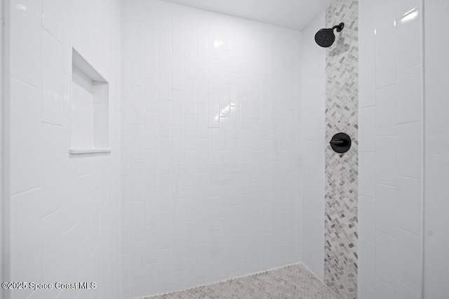 bathroom with tiled shower