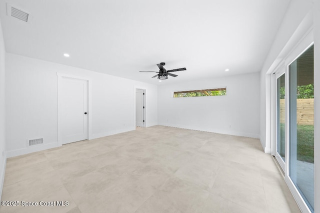 spare room featuring ceiling fan and a wealth of natural light