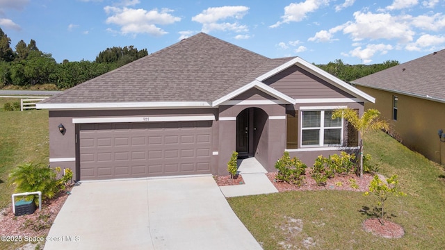 single story home featuring a garage and a front yard