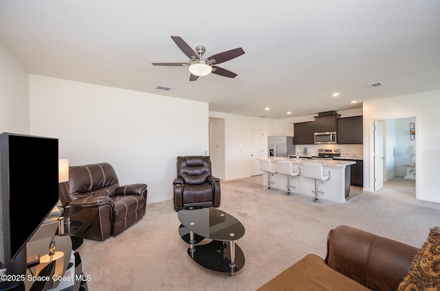 living room featuring light colored carpet and ceiling fan