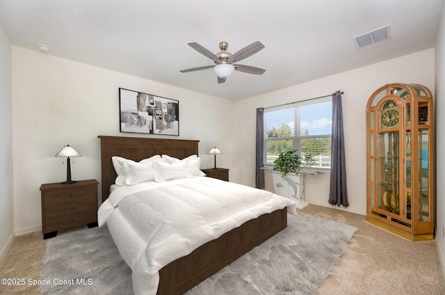 bedroom featuring light carpet and ceiling fan