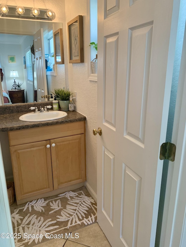 bathroom featuring tile patterned flooring and vanity