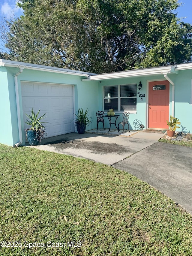 ranch-style home with a porch, a garage, and a front yard