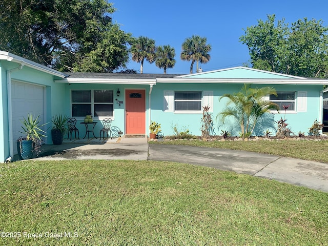 single story home with a garage, a front yard, and a porch