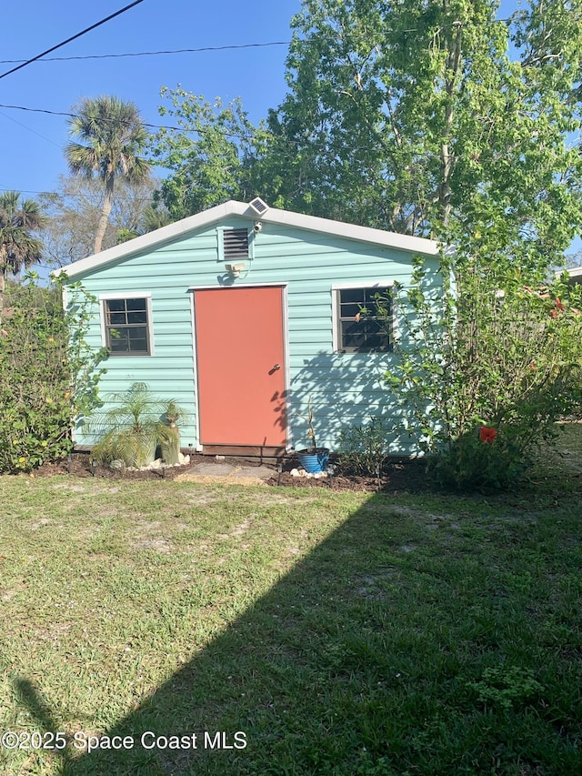 view of outbuilding featuring a yard