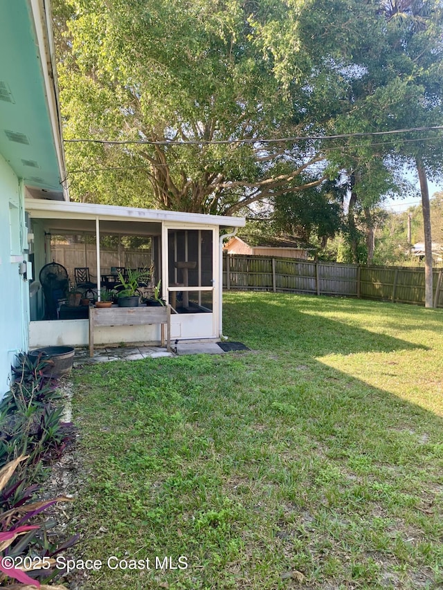 view of yard with a sunroom