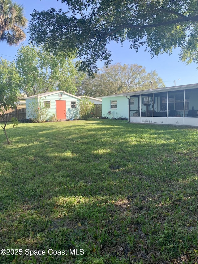 view of yard with a storage shed and a sunroom