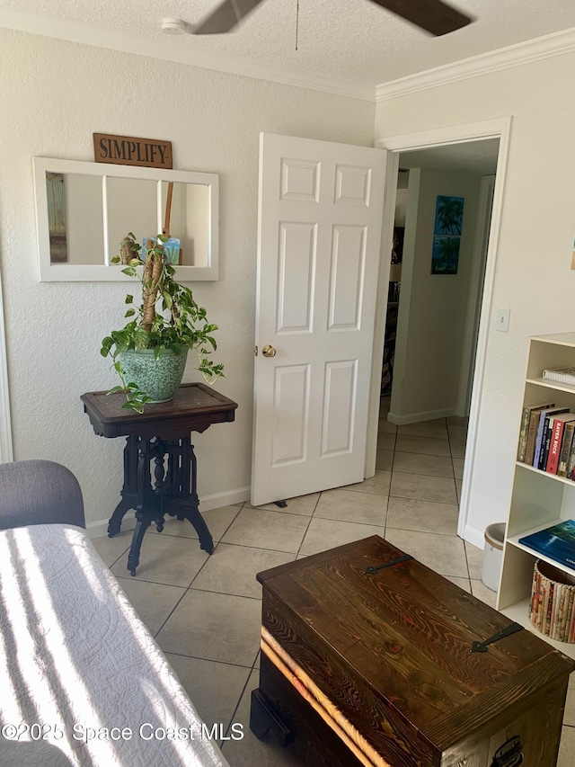 interior space featuring crown molding, a textured ceiling, and light tile patterned flooring