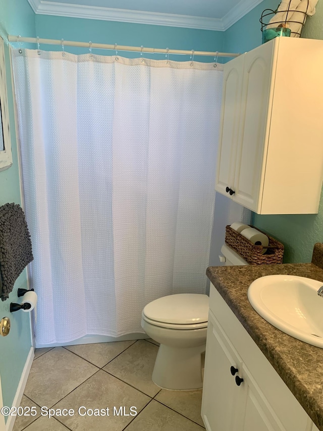 bathroom with toilet, vanity, walk in shower, crown molding, and tile patterned floors