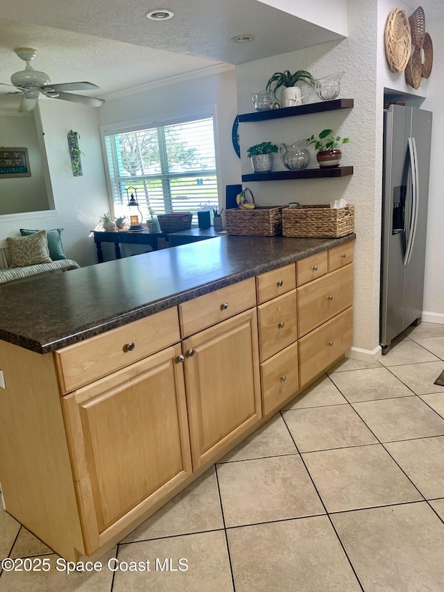 kitchen with light tile patterned flooring, crown molding, stainless steel fridge, and a textured ceiling