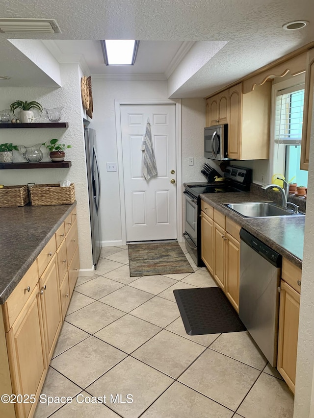 kitchen featuring sink, stainless steel appliances, ornamental molding, a textured ceiling, and light brown cabinets