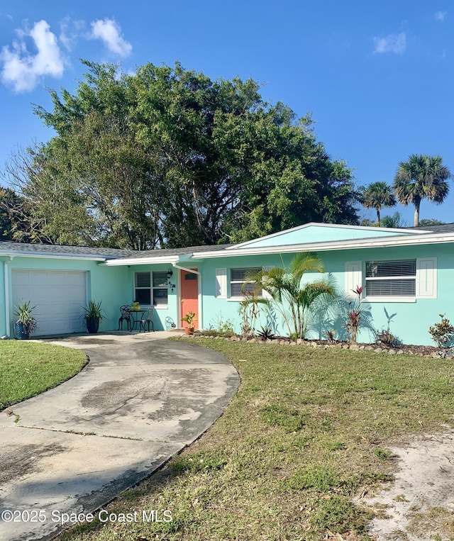 single story home featuring a garage and a front lawn