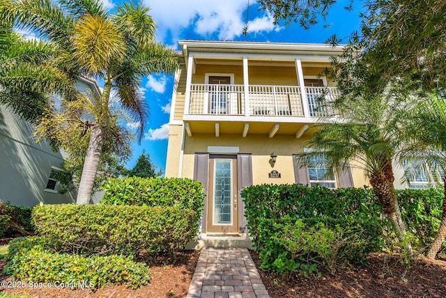 view of front of property featuring a balcony and stucco siding