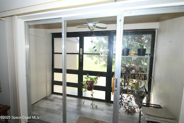 doorway featuring ceiling fan