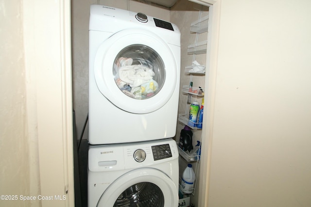 washroom featuring stacked washer / dryer